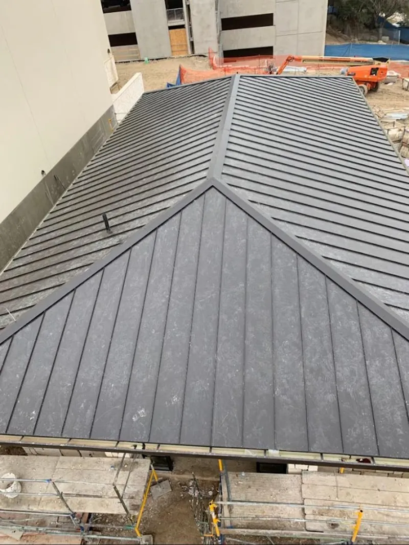 Commercial metal roof construction with crane equipment in Moncks Corner